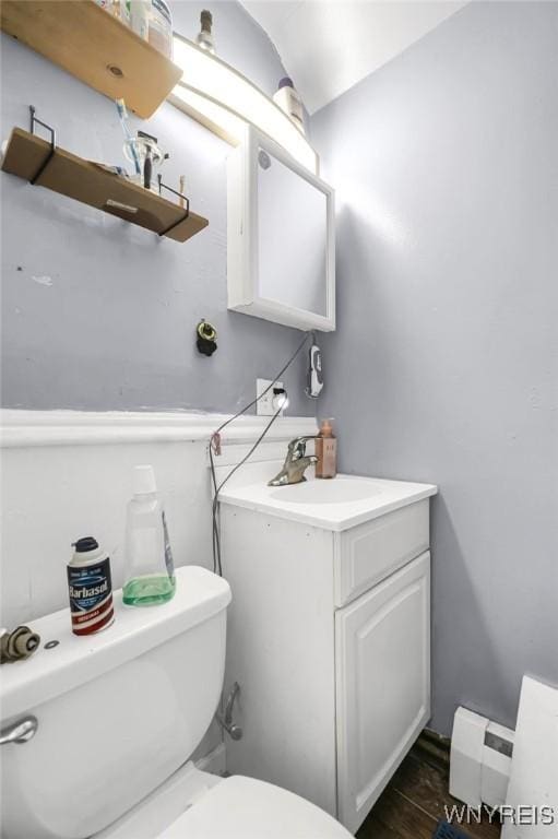 bathroom featuring hardwood / wood-style floors, toilet, and vanity