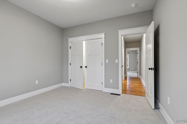 unfurnished bedroom with light carpet