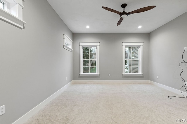 unfurnished room with light carpet and ceiling fan