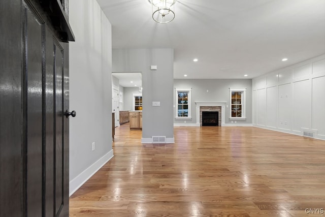 unfurnished living room featuring light wood-type flooring