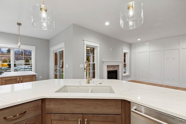 kitchen featuring dishwasher, pendant lighting, and sink