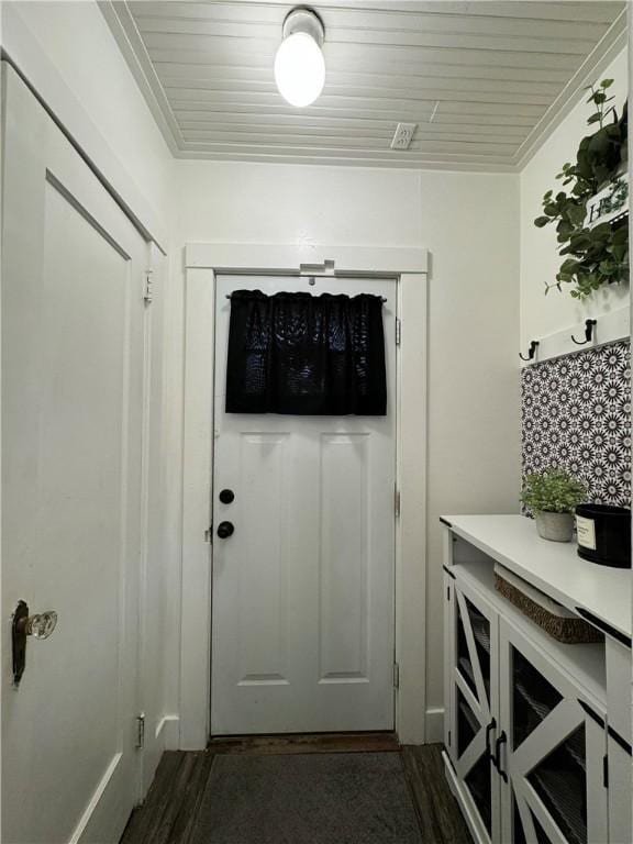 doorway to outside with crown molding, dark hardwood / wood-style floors, and wooden ceiling