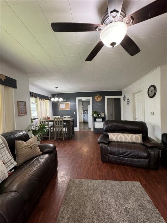 living room with dark hardwood / wood-style floors and ceiling fan