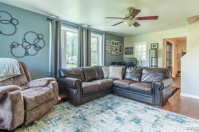 living room featuring hardwood / wood-style floors and ceiling fan