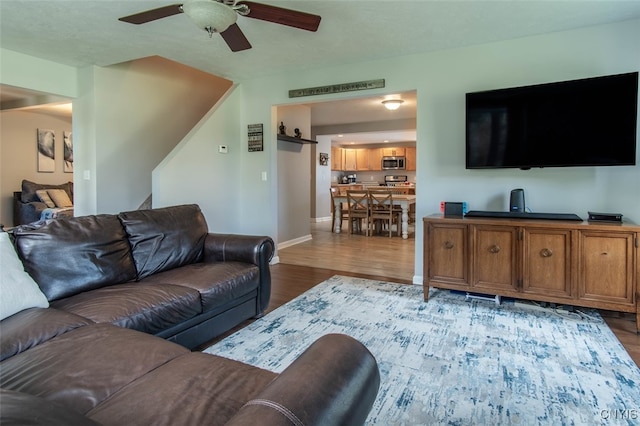 living room with hardwood / wood-style flooring and ceiling fan