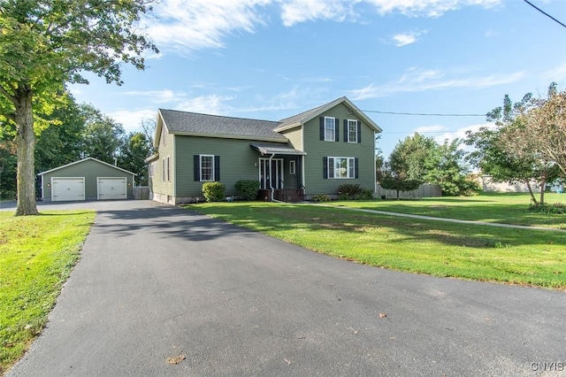 view of front facade featuring a garage, an outbuilding, and a front lawn