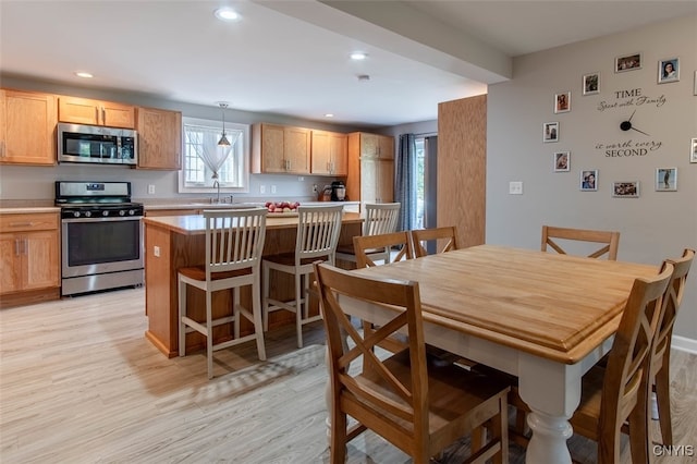 dining room featuring light hardwood / wood-style floors and sink