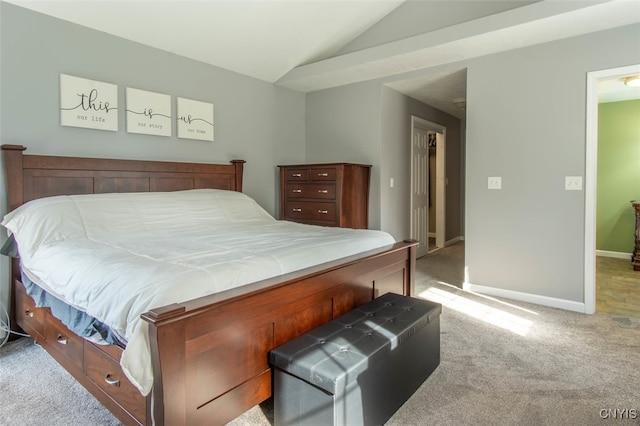 bedroom featuring light colored carpet and vaulted ceiling