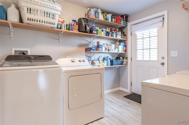 washroom with light wood-type flooring and washing machine and clothes dryer