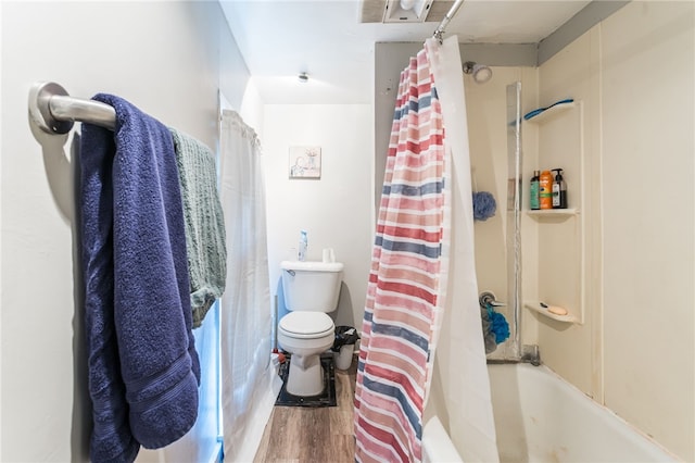 bathroom with hardwood / wood-style floors, toilet, and shower / bathtub combination with curtain