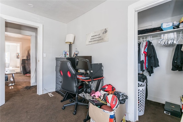 home office featuring dark colored carpet