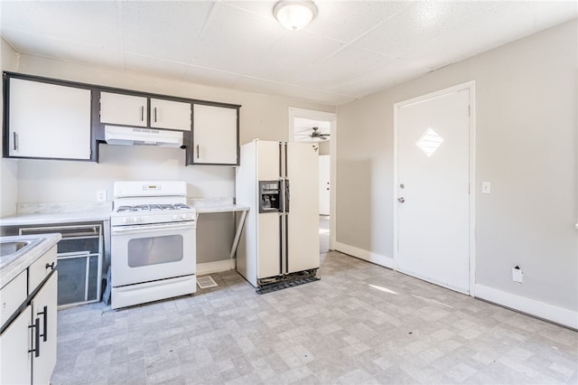 kitchen with white appliances, ceiling fan, and white cabinetry