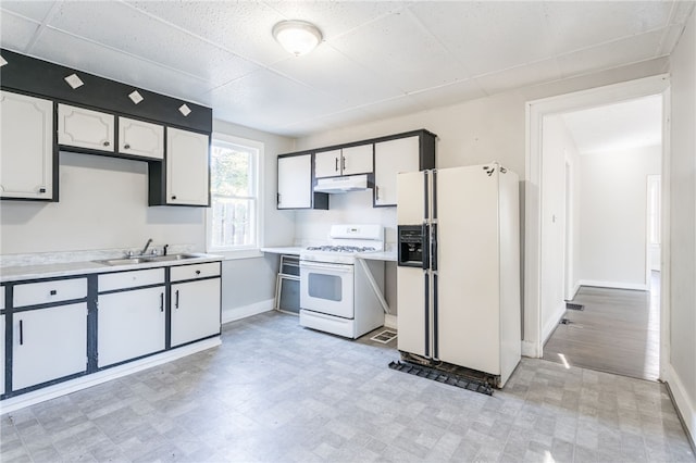 kitchen featuring white cabinets, sink, and white appliances