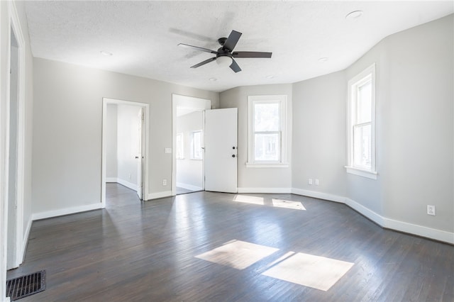 unfurnished room with ceiling fan, a textured ceiling, and dark hardwood / wood-style flooring