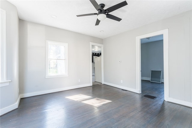 unfurnished room featuring ceiling fan and dark hardwood / wood-style floors