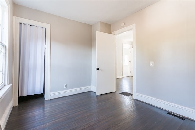 empty room with dark hardwood / wood-style floors