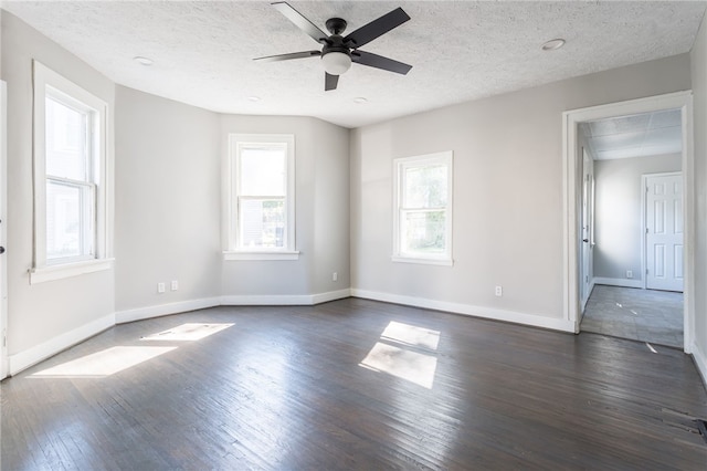 spare room with ceiling fan, a textured ceiling, and dark wood-type flooring