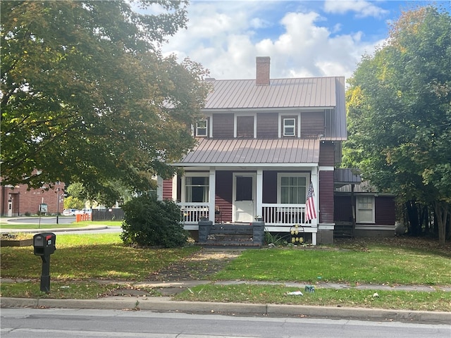 view of front of home featuring a front lawn and a porch