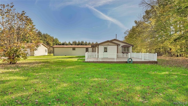 ranch-style home featuring a deck and a front lawn