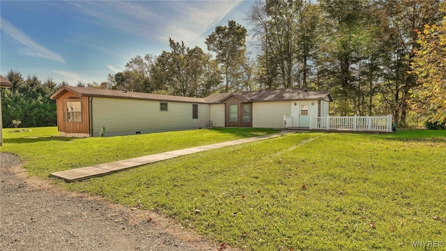 back of property featuring a yard and a wooden deck