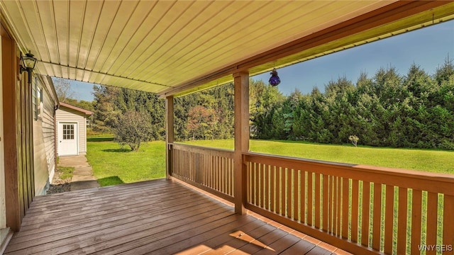 wooden terrace with a lawn