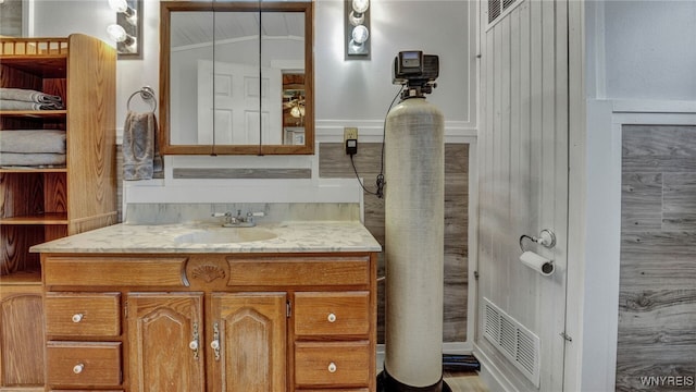 bathroom featuring lofted ceiling and vanity