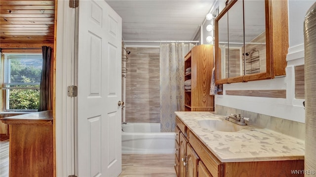 bathroom with shower / bath combination with curtain, wood-type flooring, and vanity