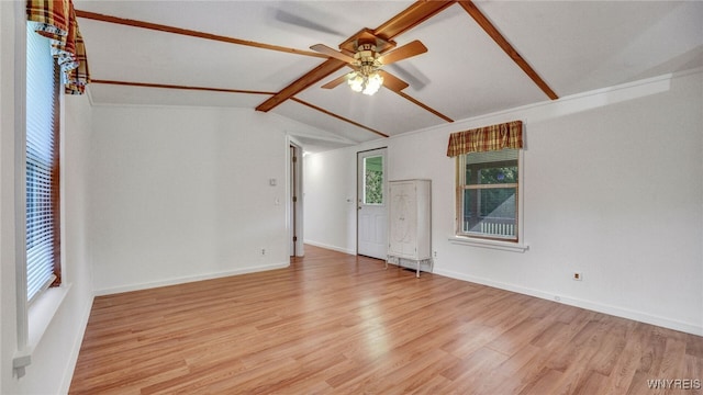 spare room with ceiling fan, light wood-type flooring, and lofted ceiling with beams