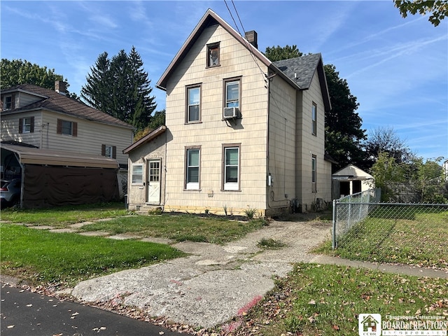 front of property with cooling unit and a front lawn