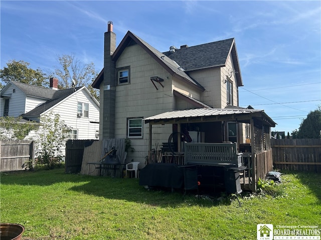 back of house featuring a yard