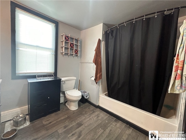 bathroom featuring shower / bath combo with shower curtain, hardwood / wood-style flooring, and toilet