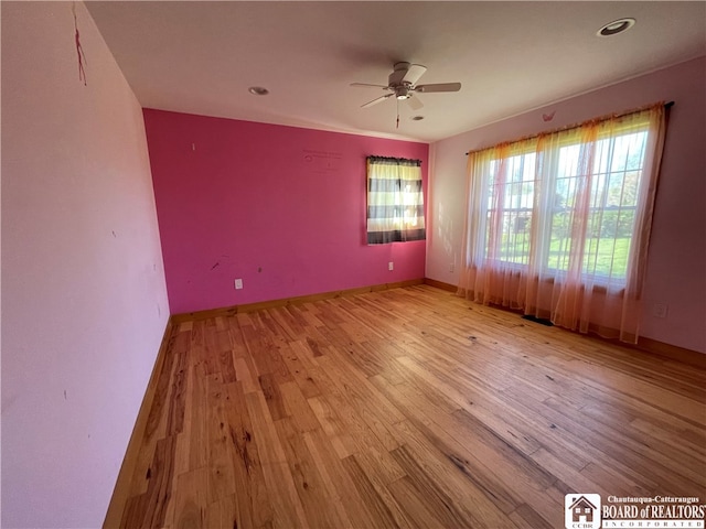 spare room featuring ceiling fan and light hardwood / wood-style floors