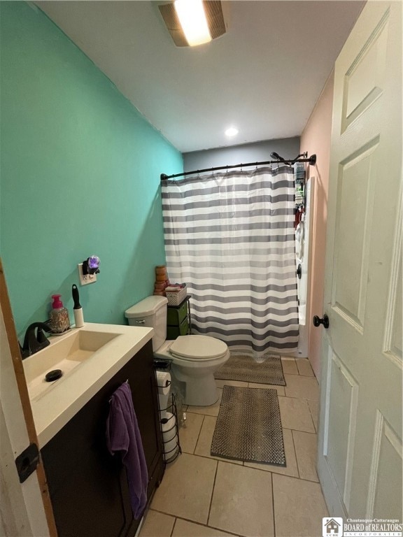 full bathroom featuring shower / bathtub combination with curtain, tile patterned flooring, vanity, and toilet