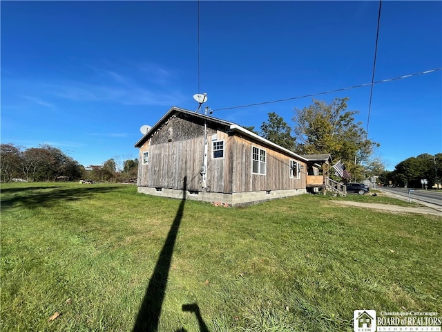 view of side of home featuring a yard