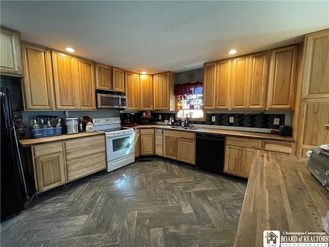 kitchen with black appliances, sink, and dark parquet flooring