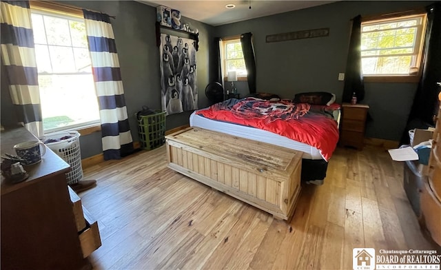 bedroom featuring light wood-type flooring and multiple windows