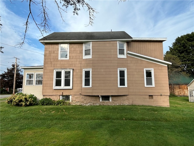 back of property featuring a lawn and central AC unit