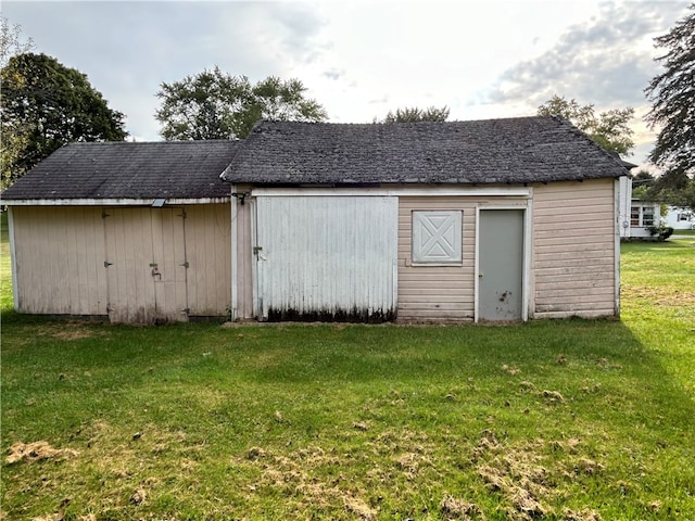 view of outdoor structure featuring a lawn