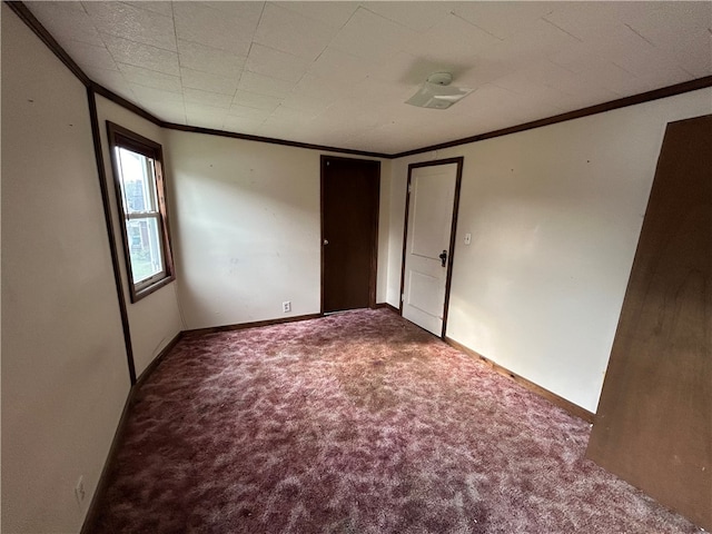 unfurnished bedroom featuring carpet flooring and crown molding