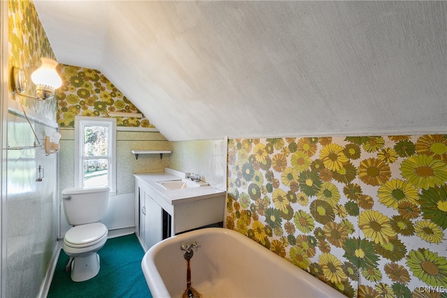 bathroom with a bathtub, vaulted ceiling, vanity, a textured ceiling, and toilet