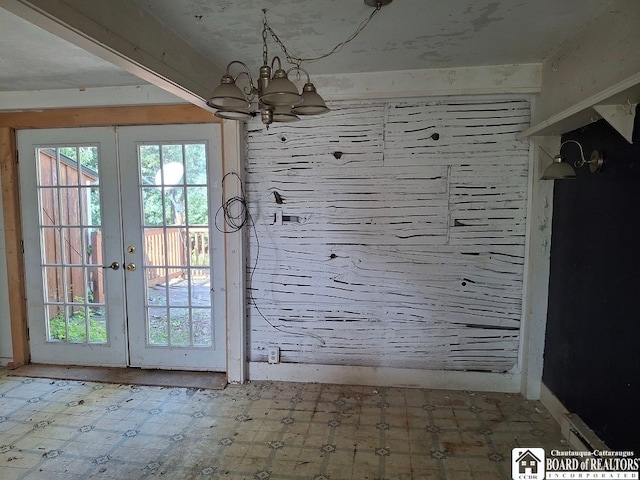 doorway with an inviting chandelier and french doors