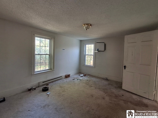 spare room with a textured ceiling and carpet floors