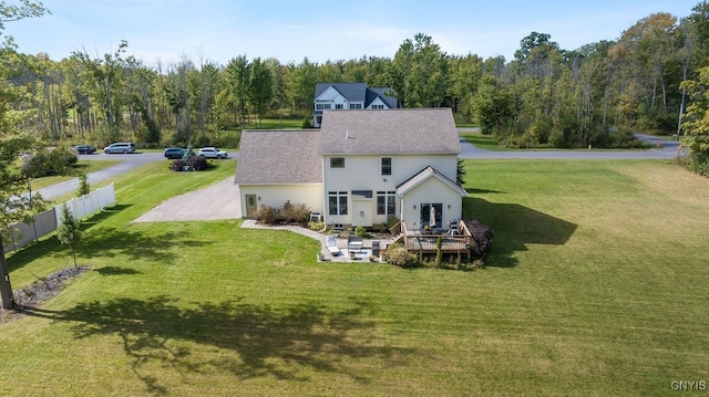 back of property featuring a lawn