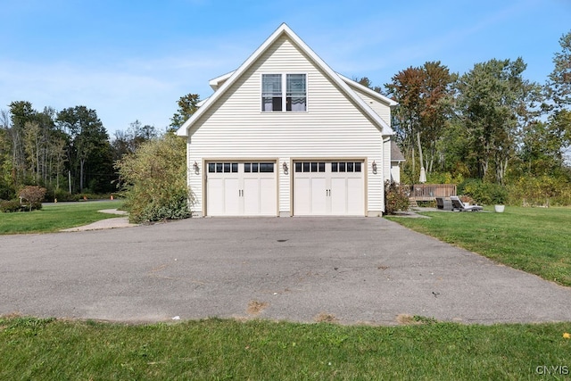 view of property exterior with a wooden deck, a yard, and a garage