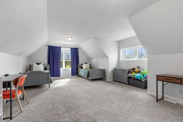 bedroom with lofted ceiling, multiple windows, and light colored carpet