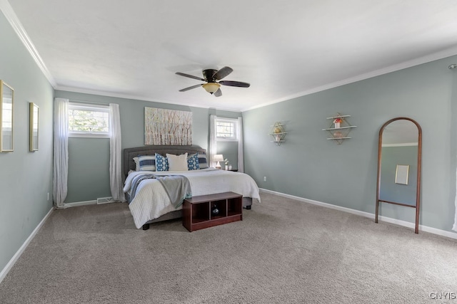 bedroom with ornamental molding, ceiling fan, and carpet floors