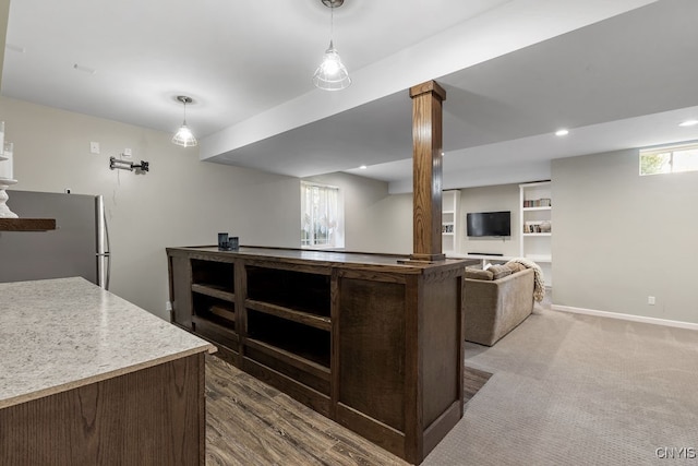 kitchen featuring decorative columns, stainless steel refrigerator, carpet flooring, and pendant lighting