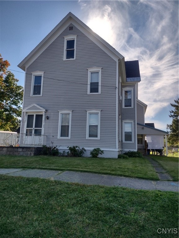 view of side of home with a lawn