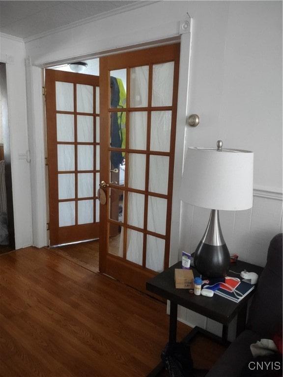 doorway featuring ornamental molding, french doors, and dark hardwood / wood-style flooring