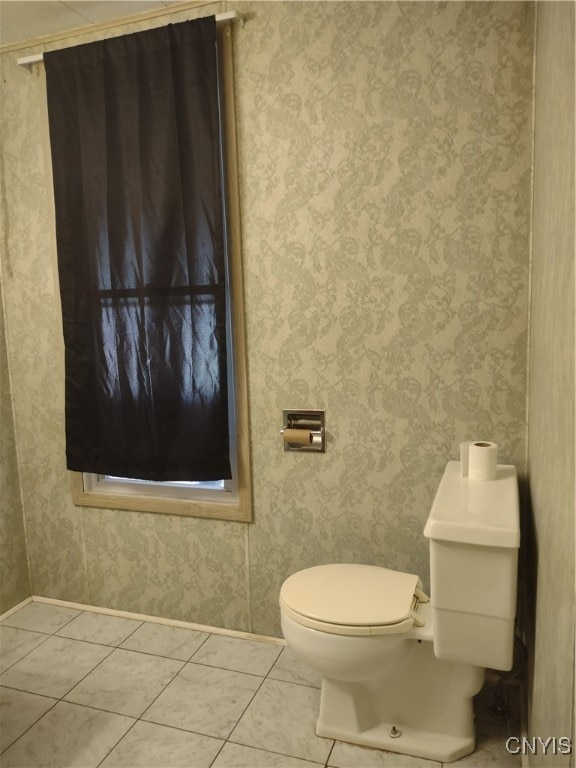 bathroom with toilet and tile patterned floors